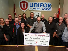 Unifor Local 444 President Dino Chiodo, centre, and union officers gather to announce $30,000 donation to Canadian Red Cross for victims of the Fort McMurray crisis Friday May 13, 2016. Gate collections at FCA Windsor Assembly Plant, Peterson Springs and Presteve Foods raised $28,600, then union officers and staffers contributed to bring the total to $30,000.