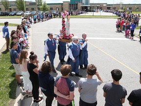 Students, staff and families from Holy Cross Catholic School in LaSalle, Ontario form a human chain in celebration of Our Lady of Fatima on May 13, 2016. May 13 is the anniversary of the apparition of Our Lady to three shepherd children in the small village of Fatima in Portugal in 1917. Fr. Michael Parent from Our Lady of Mount Carmel Catholic Church led an outdoor mass under sunny skies and warm temperatures. LaSalle Police were kind in assisting in traffic control while the roads were blocked. (JASON KRYK/WINDSOR STAR)