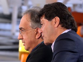 UNIFOR National president Jerry Dias, right, speaks with CEO of Fiat Chrysler Automobiles Sergio Marchione during the Fiat Chrysler launch of the 2017 Pacifica at the Windsor Assembly Plant in Windsor, Ontario.