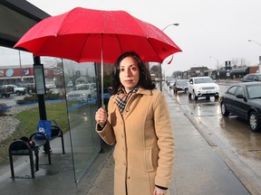 Caroline Grech of CAA South Central Ontario stands at the corner of Tecumseh Road East and Howard Avenue in Windsor on April 9, 2015. Tecumseh Road East is currently leading the area in votes for the title of worst road in the region. (Dan Janisse / The Wndsor Star)