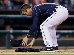 Detroit Tigers manager Brad Ausmus places his sweatshirt over home plate against the Minnesota Twins after being thrown out of the game by home plate umpire Doug Eddings in the fourth inning of a baseball game on May 16, 2016 in Detroit.