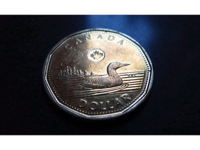 A Canadian dollar or loonie is pictured in North Vancouver, on March 5, 2014. THE CANADIAN PRESS/Jonathan Hayward