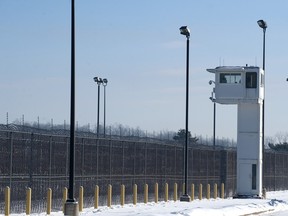 A guard tower stands over fencing at the Ionia Correctional Facility Monday, Feb. 3, 2014.  A national manhunt is underway for convicted killer Michael Elliot  who escaped from the prison on Sunday.