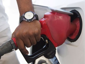 A person pumps fuel in Toronto.