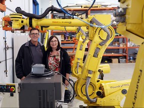 Chuck Curtiss, president, AIS Automation, Gauge & Fixture, and Shelley Fellows, vice president of operations for Radix during a media event announcing  AIS’s acquisition of Radix.