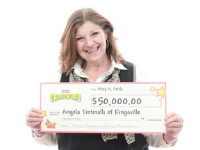 Kingsville holds her $50,000 prize cheque from playing Instant Quest for Gold Crossword.