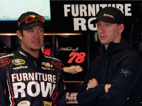 Martin Truex Jr. talks with crew chief Cole Pearn in the garage area during practice for the NASCAR Sprint Cup Series Axalta 'We Paint Winners' 400 at Pocono Raceway on June 6, 2015 in Long Pond, Pa.