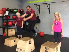 Bill Marra works the box jump as Janice Kaffer and Kelly Steele look on during a recent crossfit workout at Crossfit All Levels in Windsor.
