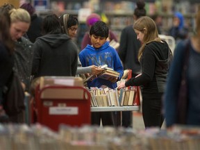 People browse through book shelves during the annual Windsor Public Library book sale on Saturday, May 14, 2016.