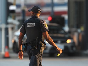 A Canada Border Services Agency officer walks near secondary inspection at the Windsor-Detroit Tunnel.