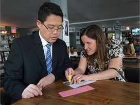 Rebecca Blaevoet, right, explains braille fundamentals to Andy Chan during a fundraising kickoff for a 3D printer at the Craft Heads Brewing Company in Windsor on Tuesday, May 31, 2016.