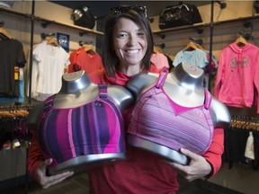 Jean Corner, a sales representative with Brooks Running, says wearing the proper sports bra is vital to a good workout. She's shown holding two versions at The Running Factory in Windsor.