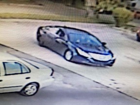 A dark blue car involved in an armed pharmacy robbery is pictured in this police handout photo.