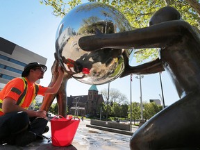 Connor Novac, 20, a summer student with the City of Windsor cleans the Windsor Rotary International Peace Monument at the Charles Clark Square in Windsor, ON on Thursday, May 19, 2016. The work is part of ongoing conservation and maintenance of city sculptures.