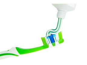 Close-up of squeezing toothpaste on toothbrush. Photo by Getty Images.