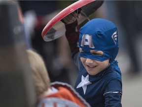Ryan Krall, 9, dressed as Captain America, battles with his friend, Rowan Jones, 8, as fans line up outside Rogues Gallery in downtown Windsor for Free Comic Book Day, Saturday, May 8, 2016.