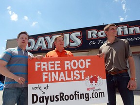 Greg Wiklanski, Frank Dayus, and Frank Dayus display a sign during a promotional event that will result in a home receiving a free roof.