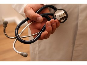 Doctor holding stethoscope.