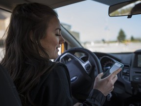 Kayla Fiala, 17, a Grade 12 student at General Amherst, tries to text while driving during Ford Driving Skills for Life at the WFCU Centre, Friday, May 6, 2016.