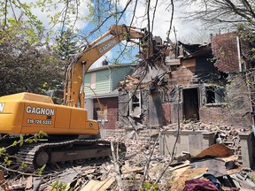 A house in the 3200 block of Edison Street is demolished on Friday, May 13, 2016, in Windsor, Ont. by workers from Gagnon Demolition. The city said the property was unsafe and granted the Ambassador Bridge company permission to demolish the home.
