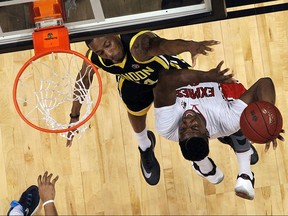 The Windsor Express' Shaquille Keith tries to fire a shot over the London Lightning's Marcus Capers during game six of the Central Conference Finals at the WFCU Centre in Windsor on Friday, May 27, 2016.