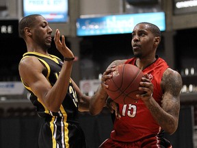 The Windsor Express' Brandon Robinson collides with the London Lightning's Marcus Capers during the NBL Central Division Finals at the WFCU Centre in Windsor on Tuesday, May 17, 2016.
