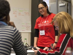 Tina Nguyen, centre, socializes as she takes part in Hacking Health Windsor-Detroit at the University of Windsor, Saturday, May 14, 2016.