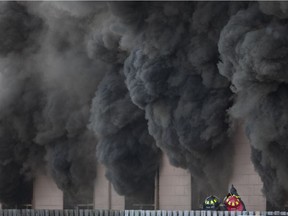 Windsor fire crews battle a large commercial fire on the 800 block of Wyandotte St. East, Monday, May 23, 2016.  The building contained a restaurant and an auto garage.