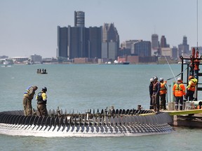 Technicians install the Peace Fountain at Coventry Gardens in Windsor, ON. on Wednesday, May 18, 2016 under sunny and mild conditions.