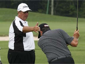In this July 28, 2011 file photo, teaching professional Matt Cole, left, works with golf student Tony Iacobelli at Kingsville Golf and Country Club.