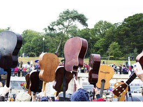 Guitars held aloft. Photo by Getty Images.