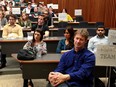 Winton Marchant, front, of Team 2, prepares to make a one-minute pitch for an accessibility app with teammates from John McGivney Centre during 2nd annual cross-border Hacking Health Windsor-Detroit 2016 at University of Windsor's Toldo Health Education Centre Friday May 13, 2016. Behind, others listen to a presentation by emcee Philip Olla and wait to make their pitch.