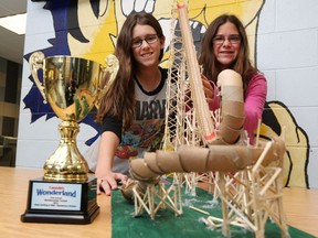St. Anthony Catholic Elementary School students Mackenzie Atanasio and cousin Katelyn Medeiros are all smiles as they display their freestanding roller-coaster creation that earned them a gold medal during a competition at Canada's Wonderland.