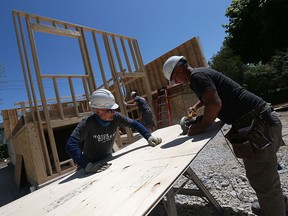 Paul Renaud and Bob Chesnik, left, join volunteers on a Habitat for Humanity build in Windsor on Thursday, May 19, 2016. Volunteers from FCA and St. Joseph's High School were on hand to assist with the framing.