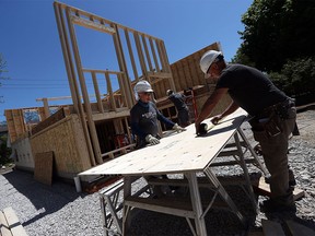 Paul Renaud and Bob Chesnik, right, join volunteers on a Habitat for Humanity build in Windsor on  May 19, 2016.