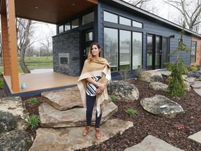 Stefanie Goulding, general manager of Rochester Place Golf Club and Resort in Lakeshore, Ont., stands in front of one of the many short-term homes available on April 21, 2016.  The golf resort has expanded and is now offering stay and play packages.