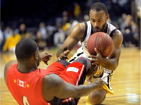 London Lightning guard Akeem Scott battles for a loose ball with Windsor Express point guard Sherron Collins during the first half of a National Basketball League of Canada game at Budweiser Gardens in London, Ont., on May 15, 2016.