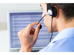 Telemarketer on the phone. Photo by Getty Images.