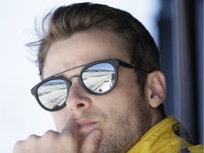 Marco Andretti watches road testing from pit row for a future IndyCar auto race at Texas Motor Speedway on May 3, 2016, in Fort Worth, Texas.