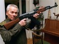 FILE- In this Wednesday, Oct. 29, 1997 file photo Mikhail Kalashnikov shows a model of his world-famous AK-47 assault rifle at home in the Ural Mountain city of Izhevsk, 1000 km (625 miles) east of Moscow, Russia. Kalashnikov, whose work as a weapons designer for the Soviet Union is immortalized in the name of the world's most popular firearm, died Monday at the age of 94 in a hospital of the city of Izhevsk where he lived. The AK-47 has been favored by guerrillas, terrorists and the soldiers of many armies. An estimated 100 million guns are spread worldwide.