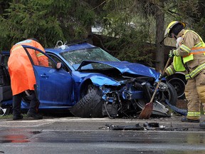Police and firefighters survey the damage to a Mazda RX-8 after a single vehicle accident on Front Road in LaSalle on Tuesday, May 10, 2016.