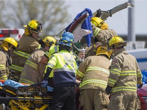 Emergency crews work to free a man from a vehicle after a two-car collision on County Rd. 22 and East Pike Creek Rd., Sunday, May 8, 2016.