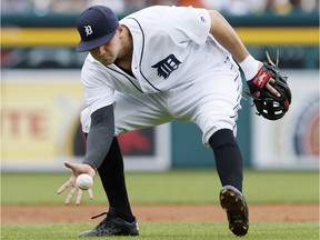 Detroit Tigers third baseman Nick Castellanos barehands a grounder hit by Texas Rangers' Delino DeShields and throws him out during the second inning of a baseball game Saturday, May 7, 2016, in Detroit.