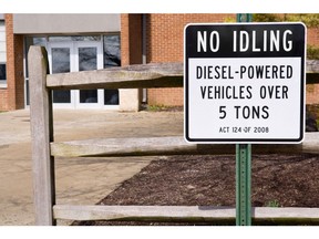 No Idling sign in front of fence. Photo by Getty Images.