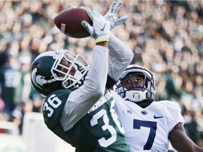 Arjen Colquhoun (36) of the Michigan State Spartans makes an interception in the end zone of a pass intended for Geno Lewis (7) of the Penn State Nittany Lions in a game at Spartan Stadium on Nov. 28, 2015 in East Lansing, Mich.