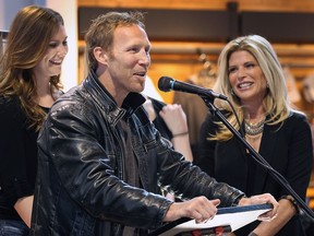 Former National Hockey League player Ryan VandenBussche speaks at a news conference Wednesday where he was announced as this year's road captain for the Bob Probert Ride. Brogan Probert, left, and Dani Probert look on.