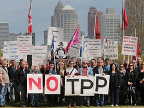 In this file photo, a group protesting the Trans-Pacific Partnership proposal demonstrate on Riverside Dr. on Thursday, May 12, 2016, in front of the Best Western hotel where the House of Commons International Trade Committee was meeting regarding the issue.