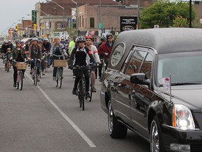 Cyclists follow a hearse down Wyandotte Street east during the Ride of Silence, an annual memorial dedicated to those who have been injured or killed while riding their bicycles.