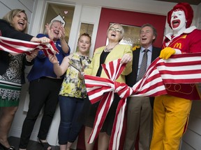 Cathy Loblaw, president and CEO of Ronald McDonald House Charities Canada, left, Lou-Anne Farrell, Jaycie LeClair, 13, Margaret Anderson, Bob Renaud, chair of the board at Windsor Regional Hospital, and Ronald McDonald, cut the ribbon for the new Ronald McDonald House Windsor at Windsor Regional Hospital - Met Campus, Friday, May 6, 2016.