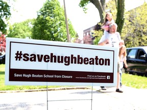 Parent Steve Walsh wears a #SaveHughBeaton shirt while walking with his daughters Daisy and Dahlia after class at Hugh Beaton School in Windsor, Ont. on May 16, 2016.
